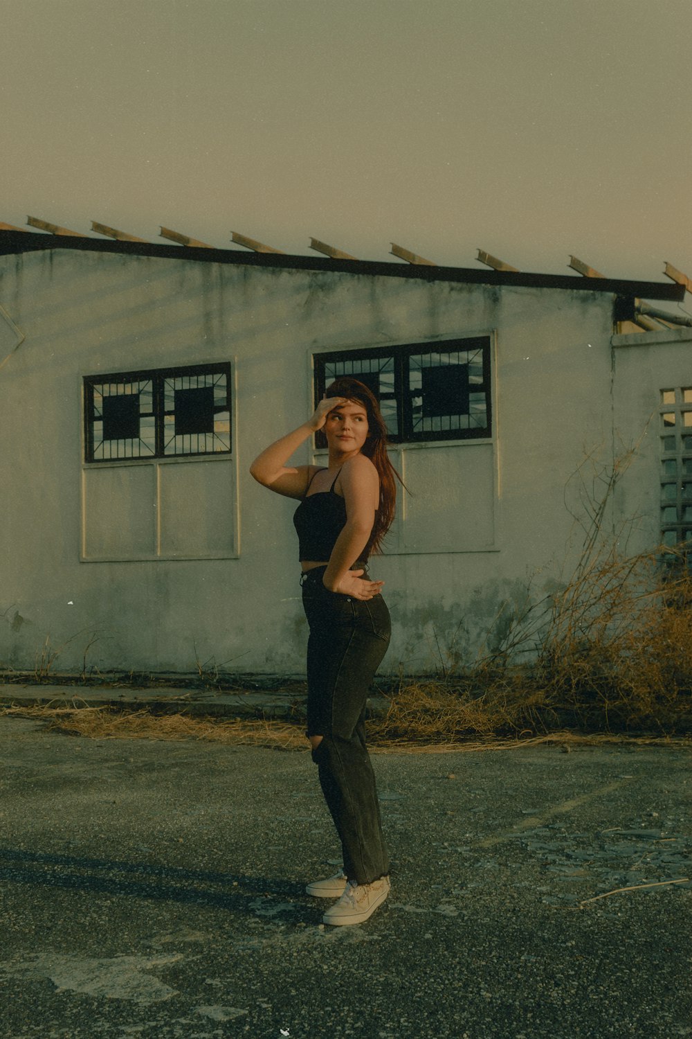 a woman standing in front of a white building