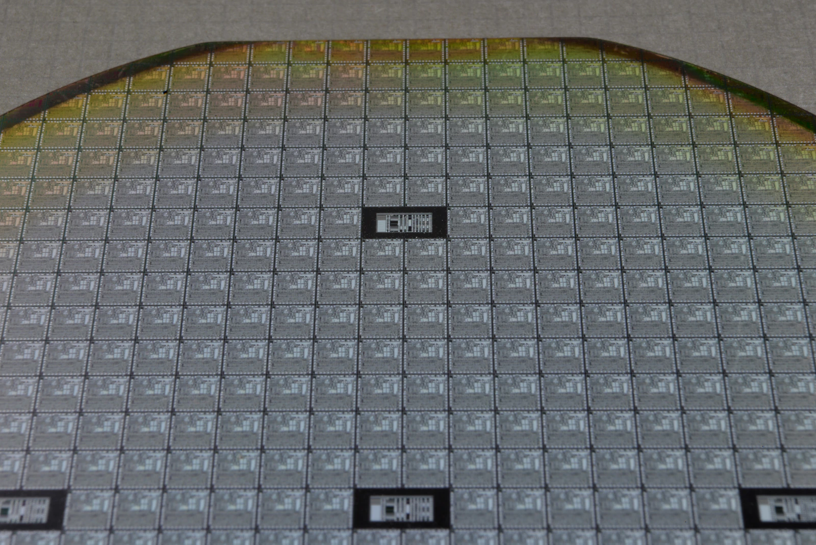 Macro photograph of a silicon wafer, illustrating semiconductor materials development rather than an IQE or Atomera GaN wafer