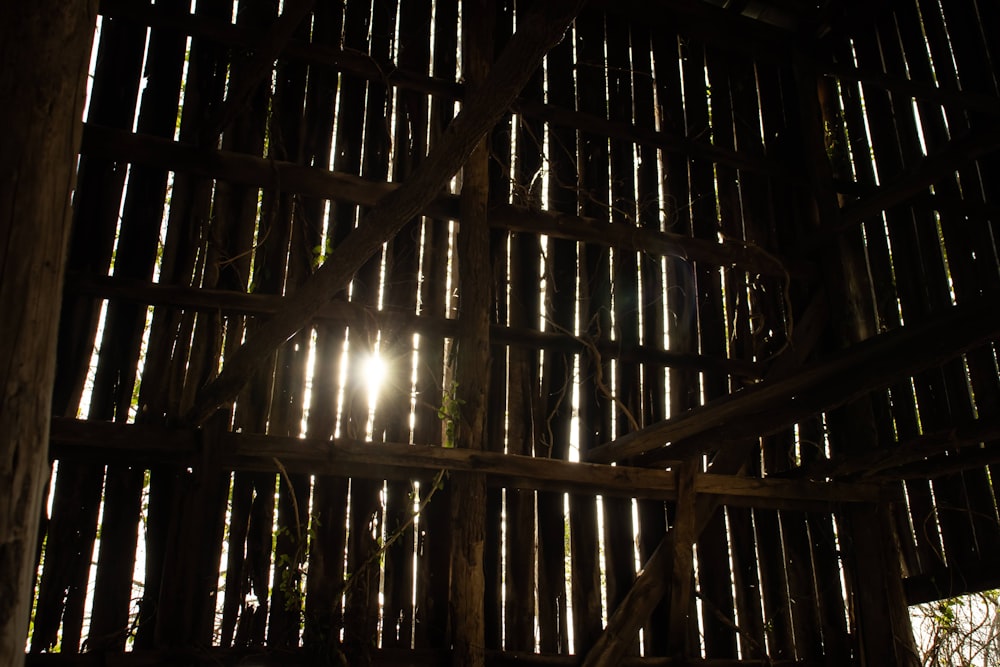 the sun is shining through the wooden slats