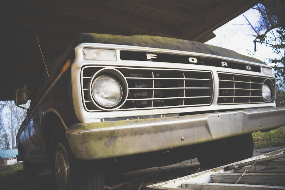 an old ford truck sitting in a garage