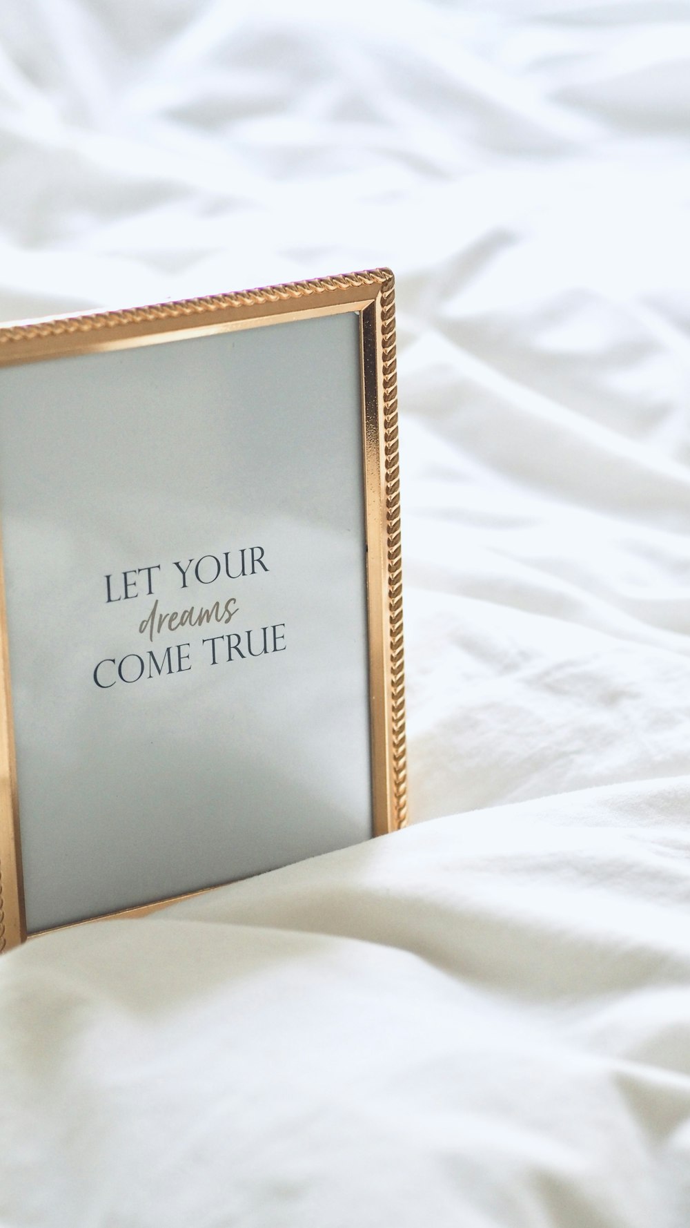 a picture frame sitting on top of a bed