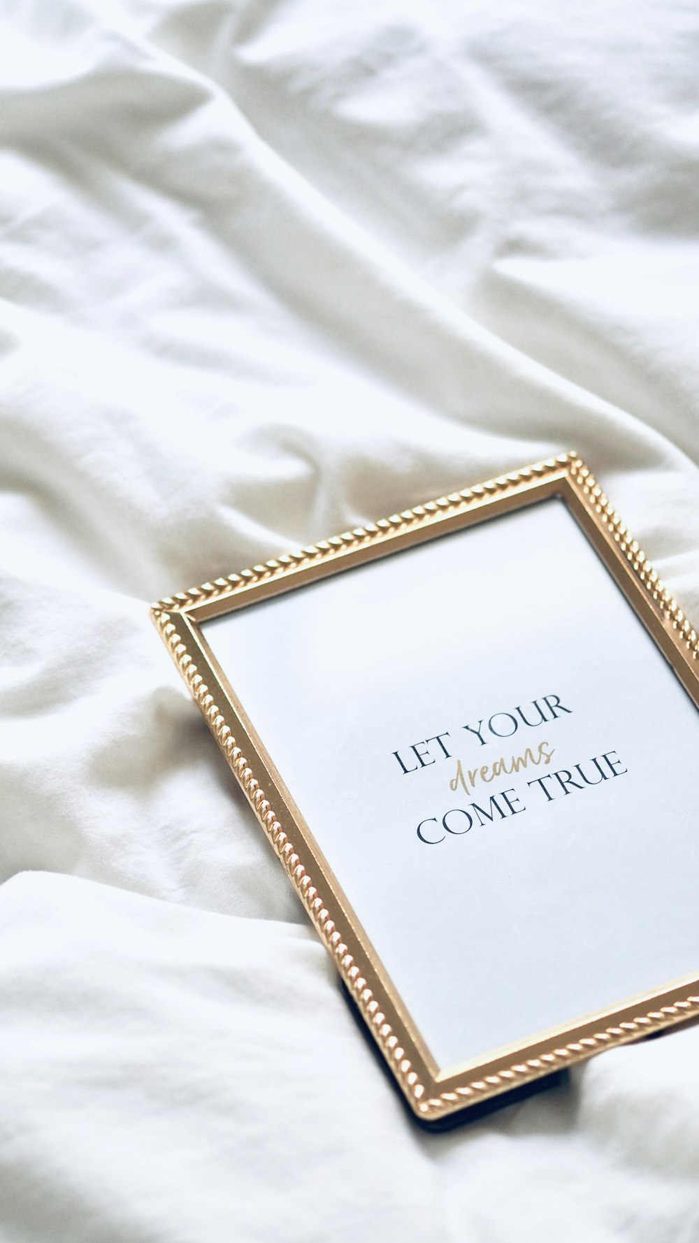 a picture frame sitting on top of a bed