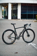 A sleek delivery bike parked outside a modern building with colorful branding.