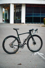 A sleek modern tandem bike with aerodynamic design on an urban street.