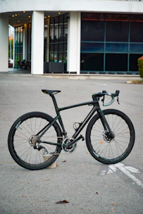 A sleek modern tandem bike with aerodynamic design on an urban street.