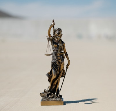 a statue of a lady justice holding a scale