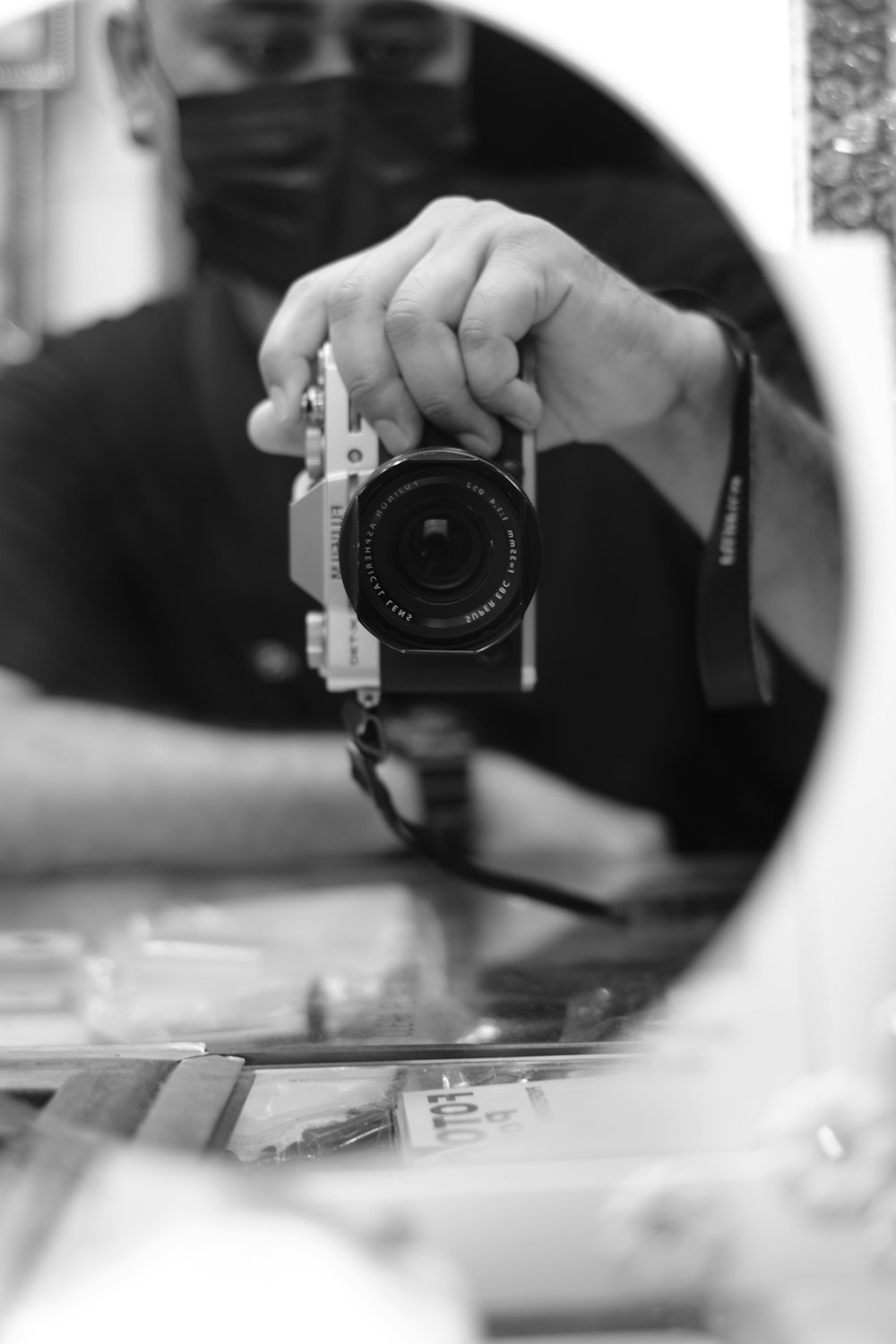 a man holding a camera in front of a mirror