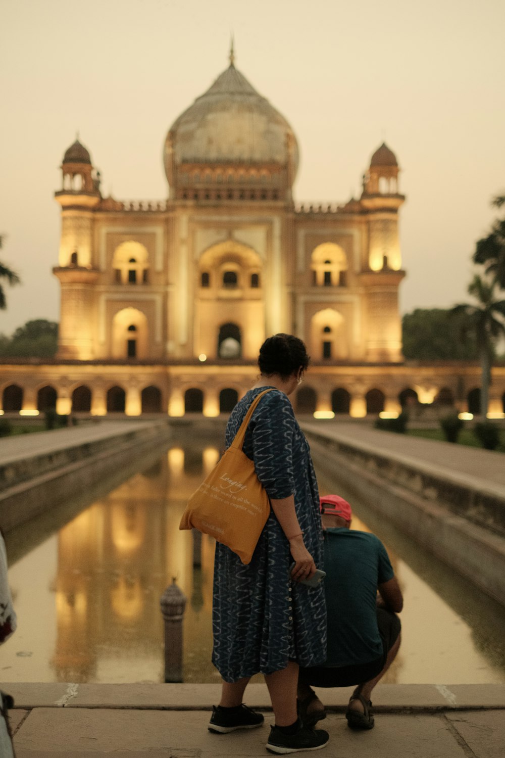 a man and a woman standing in front of a building