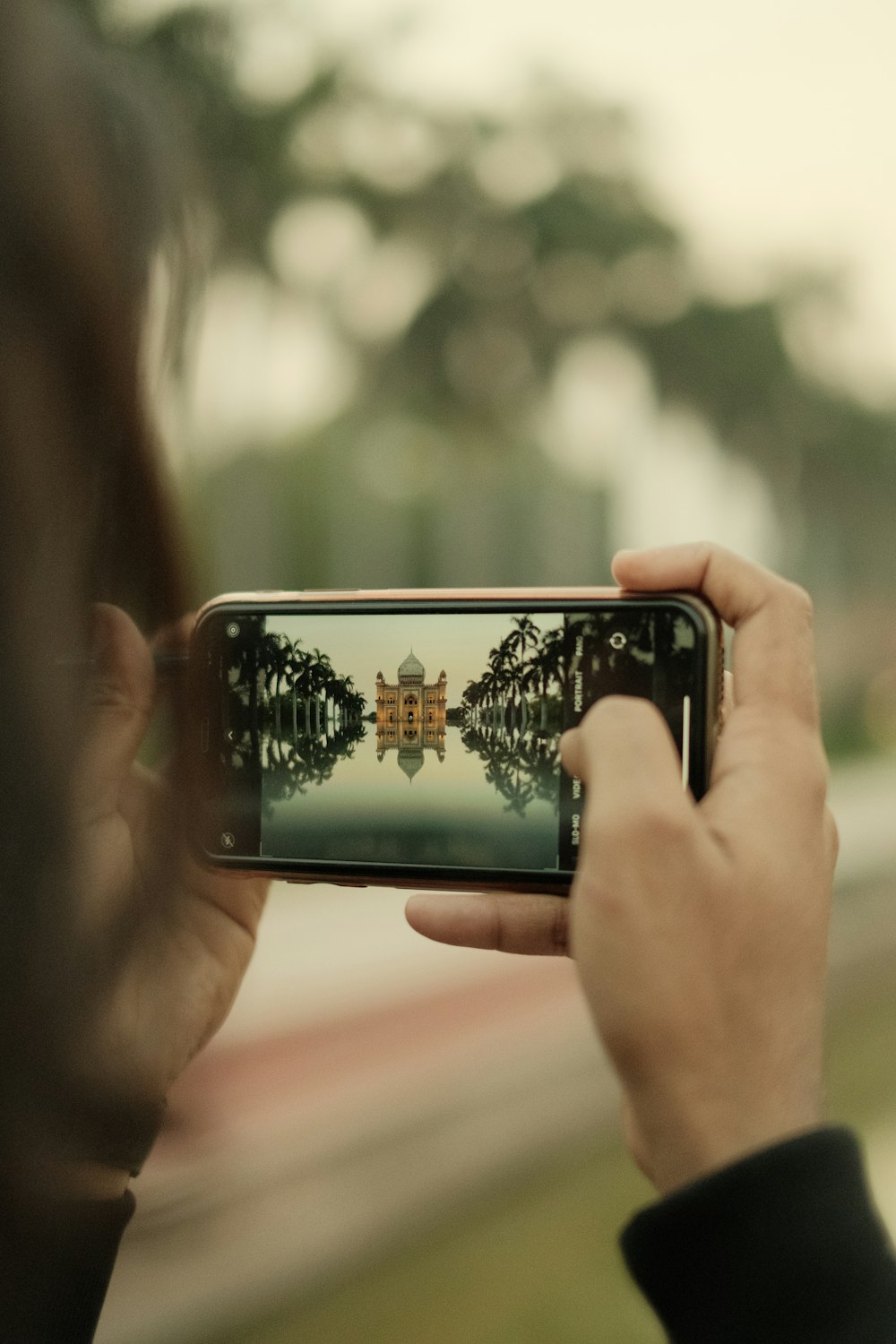 a person taking a picture with a cell phone