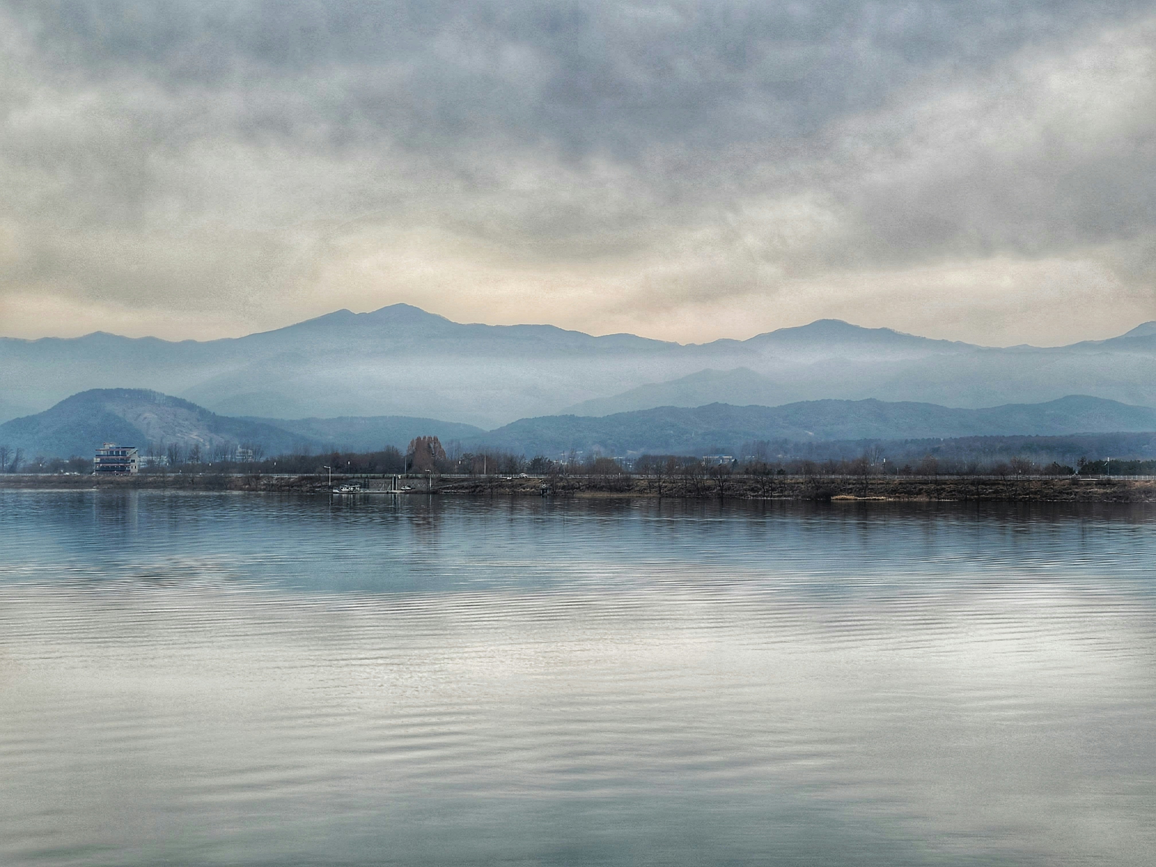 a large body of water with mountains in the background