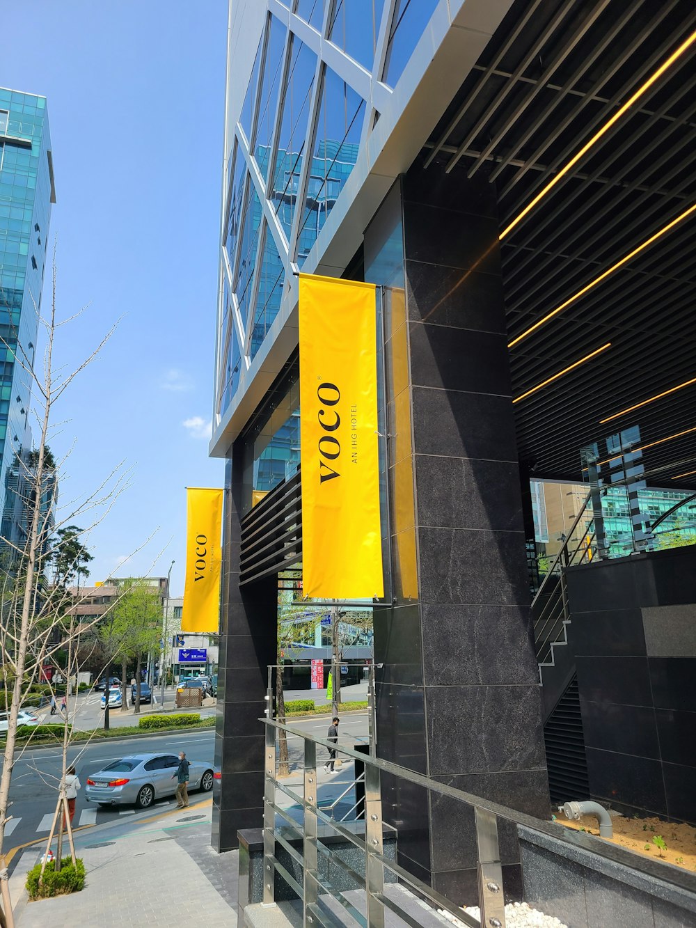 a building with a yellow sign hanging from it's side