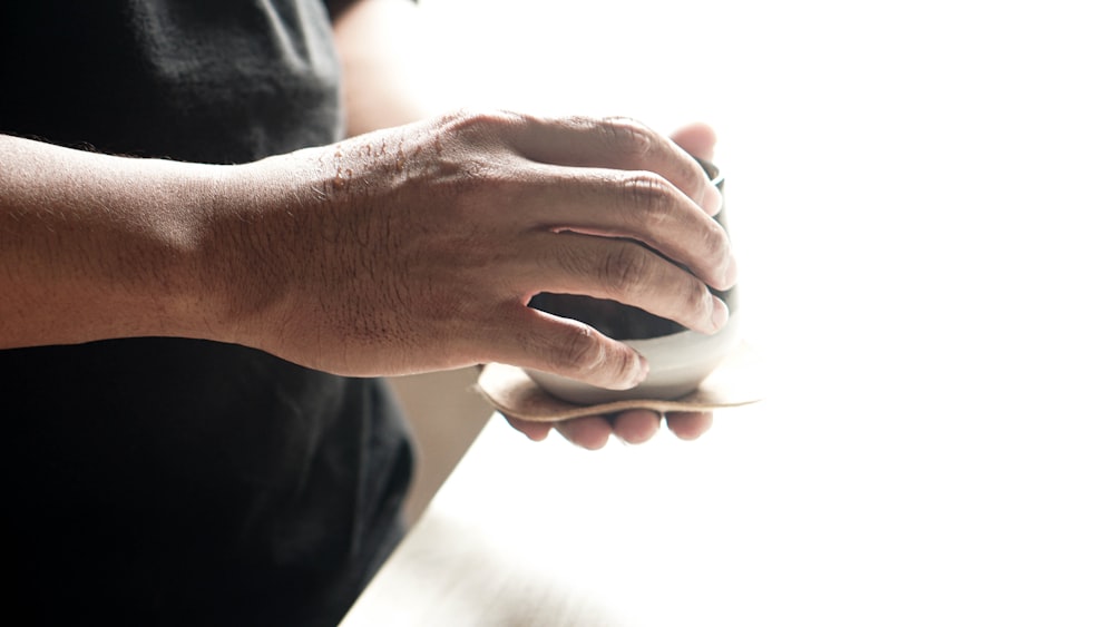 a person holding a computer mouse in their hand