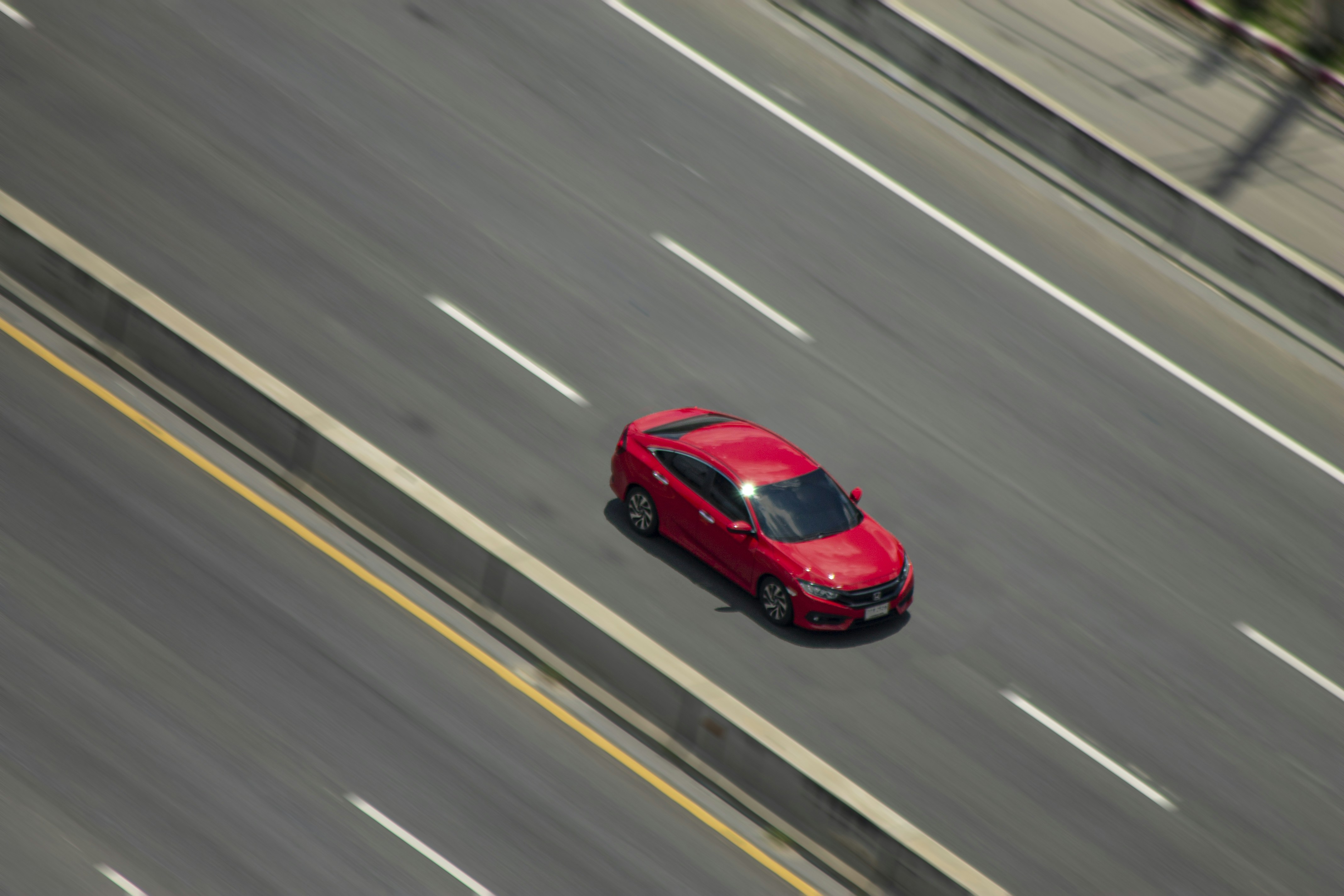 Used Tesla Model 3 driving on a highway, representing long-range commuting capability