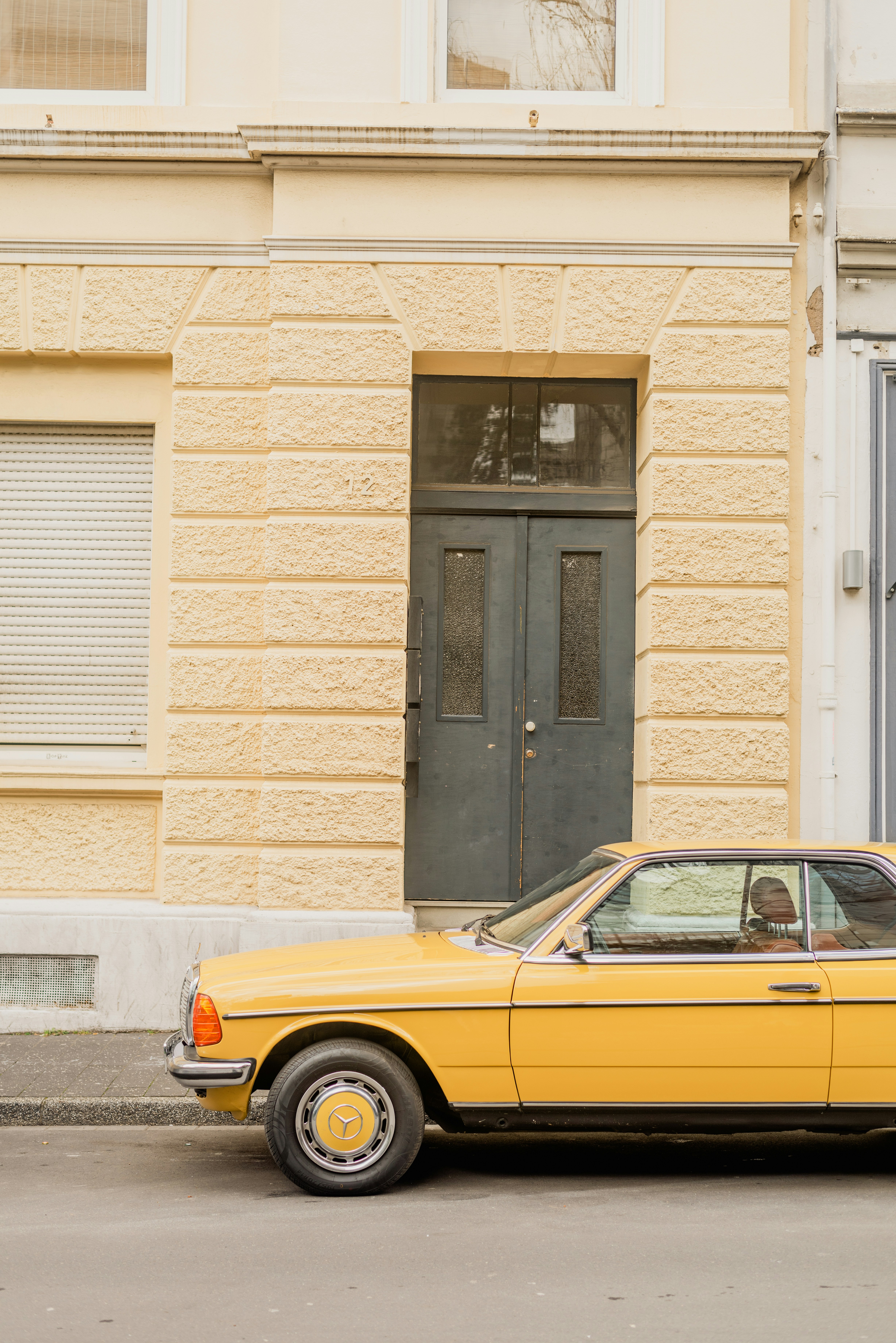 a yellow car parked in front of a building