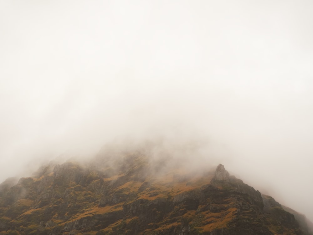 a very tall mountain covered in fog and clouds