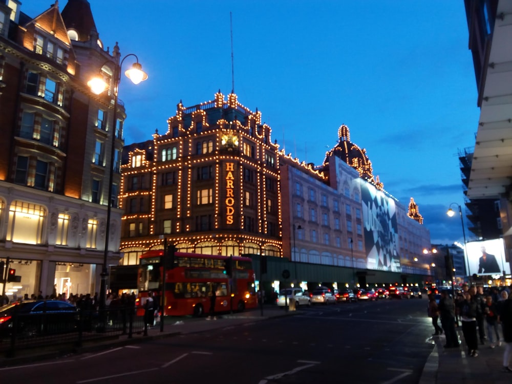 a city street at night with a building lit up