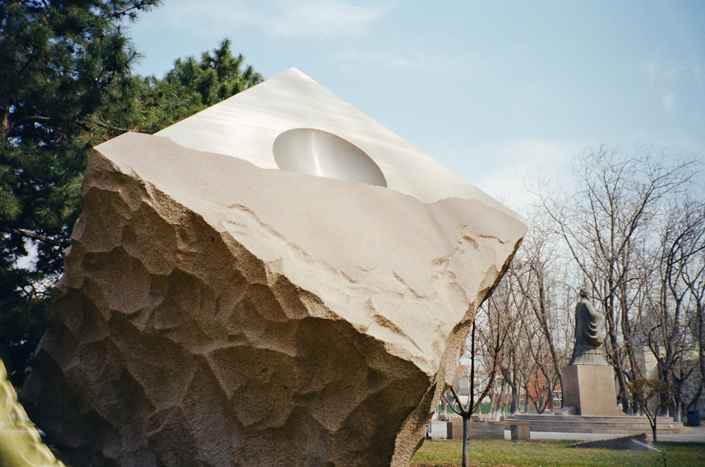 a large rock with a sculpture in the middle of it