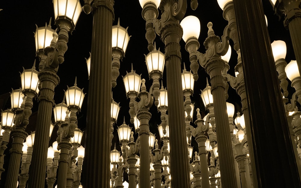 a group of street lamps lit up at night
