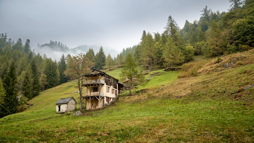 a house sitting on top of a lush green hillside