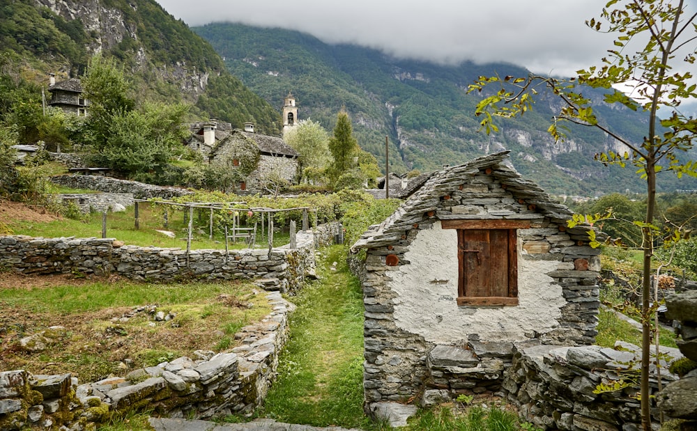 a small stone building with a wooden door