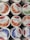 Several tubs of Swiss Premium Yogurt are displayed. The flavors visible include strawberry, aloe vera, and blueberry. The labels indicate that the yogurt is low-fat and made in Switzerland, with images of the corresponding fruits on each tub.