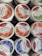 Several tubs of Swiss Premium Yogurt are displayed. The flavors visible include strawberry, aloe vera, and blueberry. The labels indicate that the yogurt is low-fat and made in Switzerland, with images of the corresponding fruits on each tub.