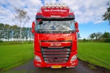 A vibrant cherry red and white truck on the road.