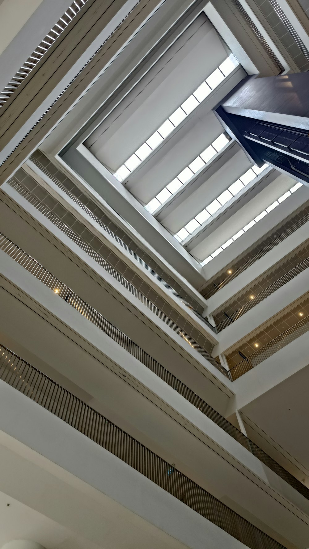 a blue and white umbrella hanging from a ceiling