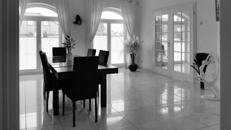 a black and white photo of a dining room