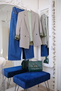 a blue bench sitting in front of a mirror