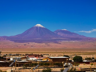 a large mountain towering over a small town