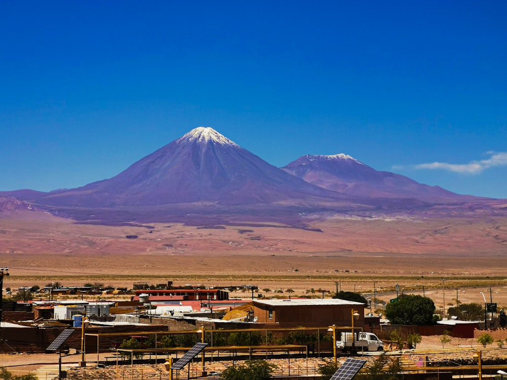 a large mountain towering over a small town