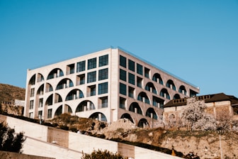 a large white building on top of a hill