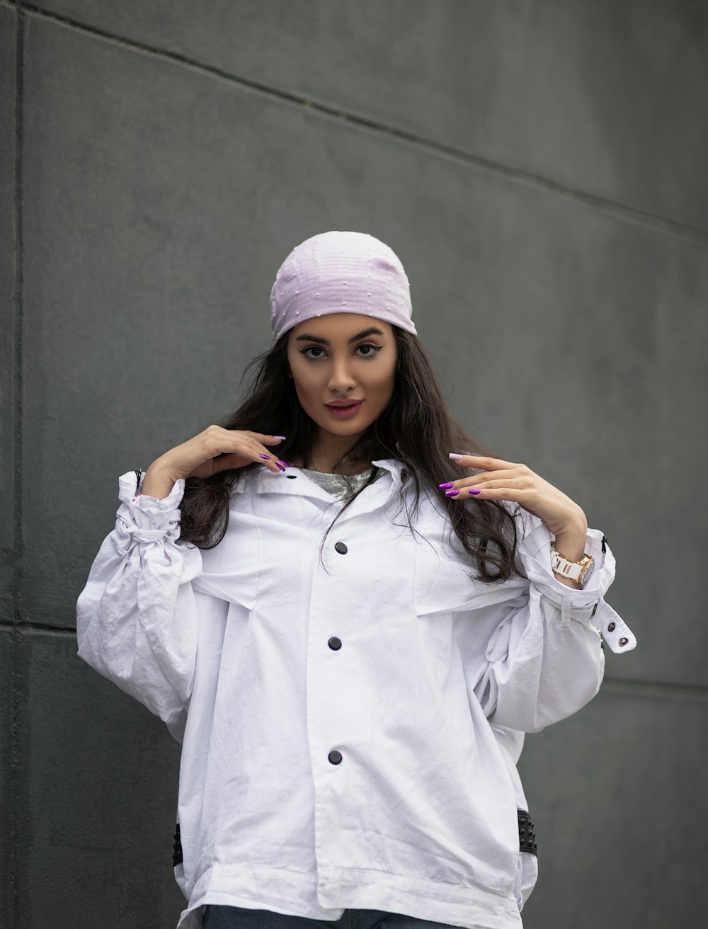 a woman wearing a white jacket and a pink hat