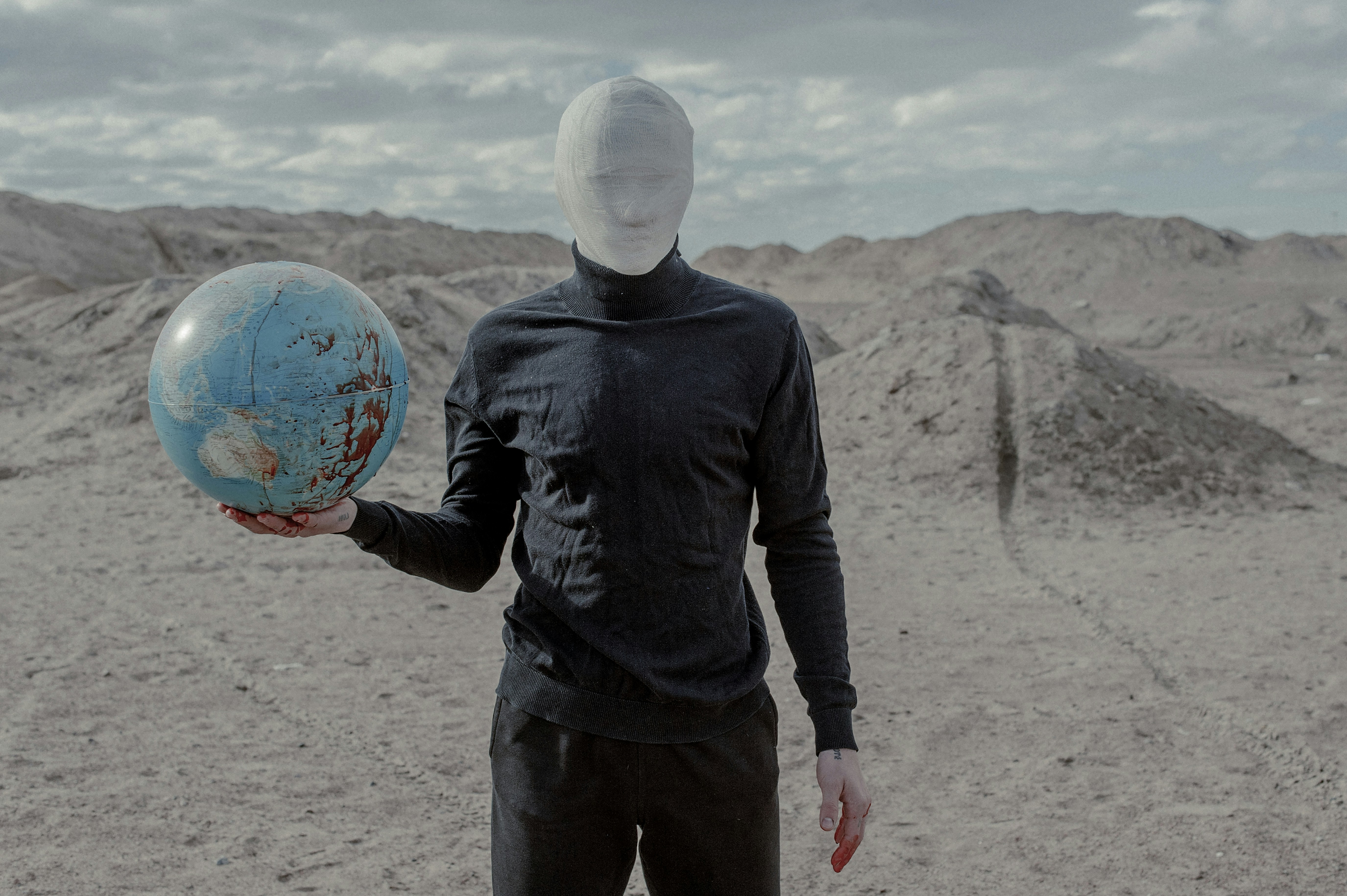 a man in a black shirt holding a blue ball