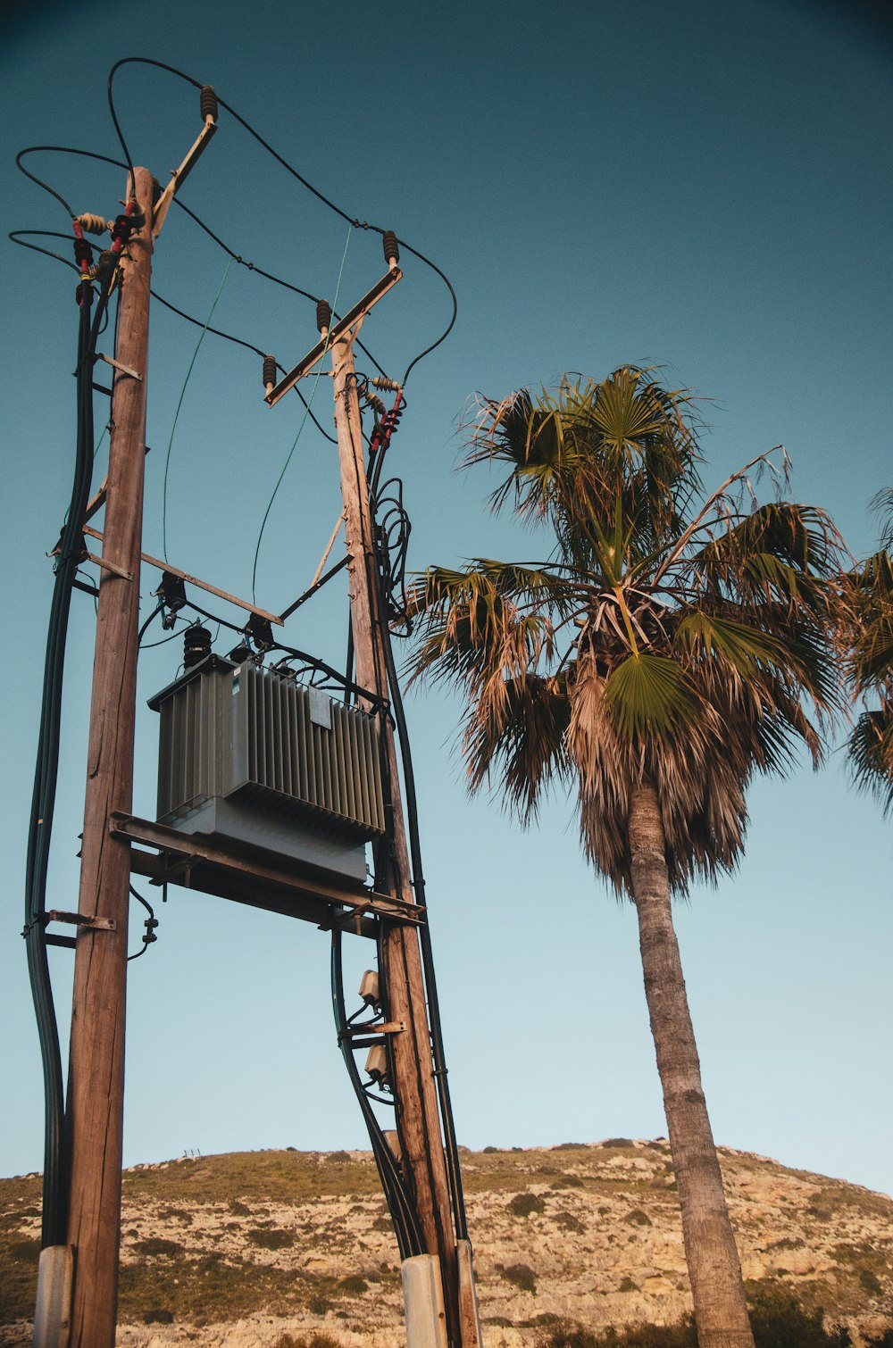 a telephone pole with a telephone box on top of it