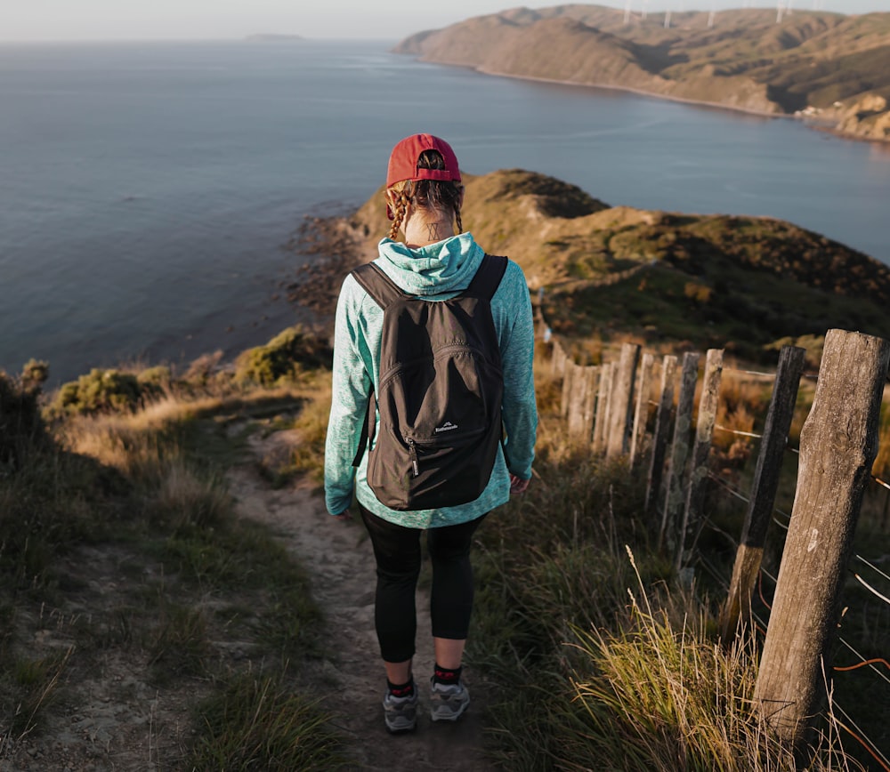 a person with a backpack walking up a hill