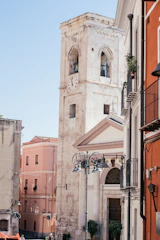 a tall white clock tower towering over a city