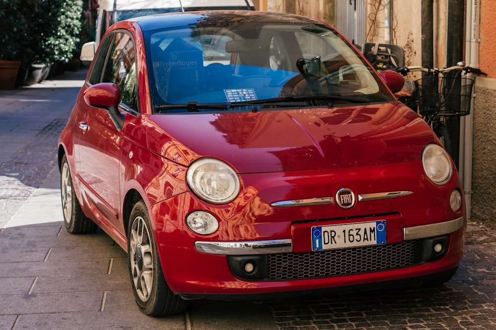 a red car parked on the side of a street