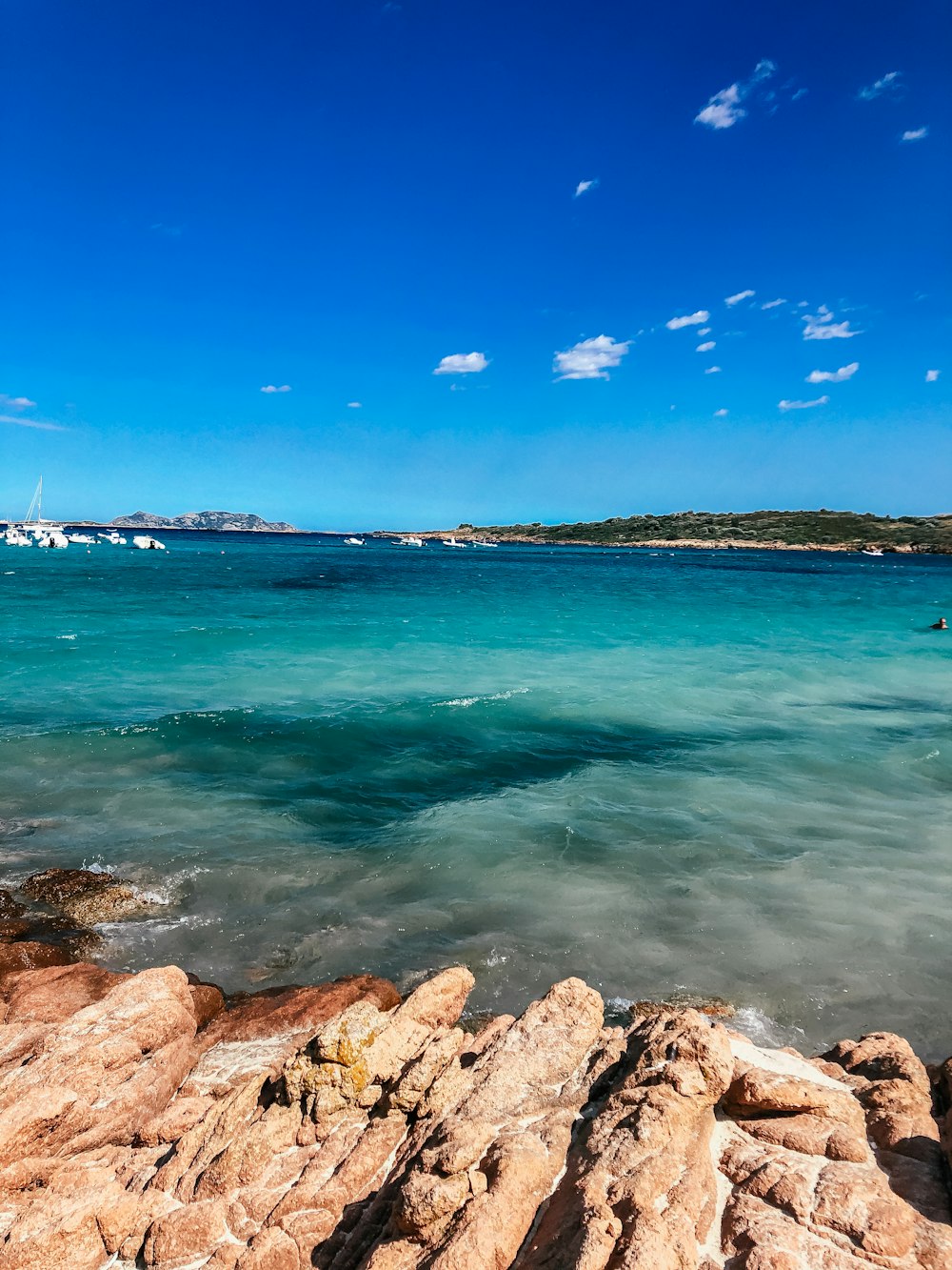 a view of the ocean from a rocky shore