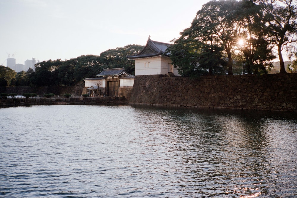 a body of water with a building in the background