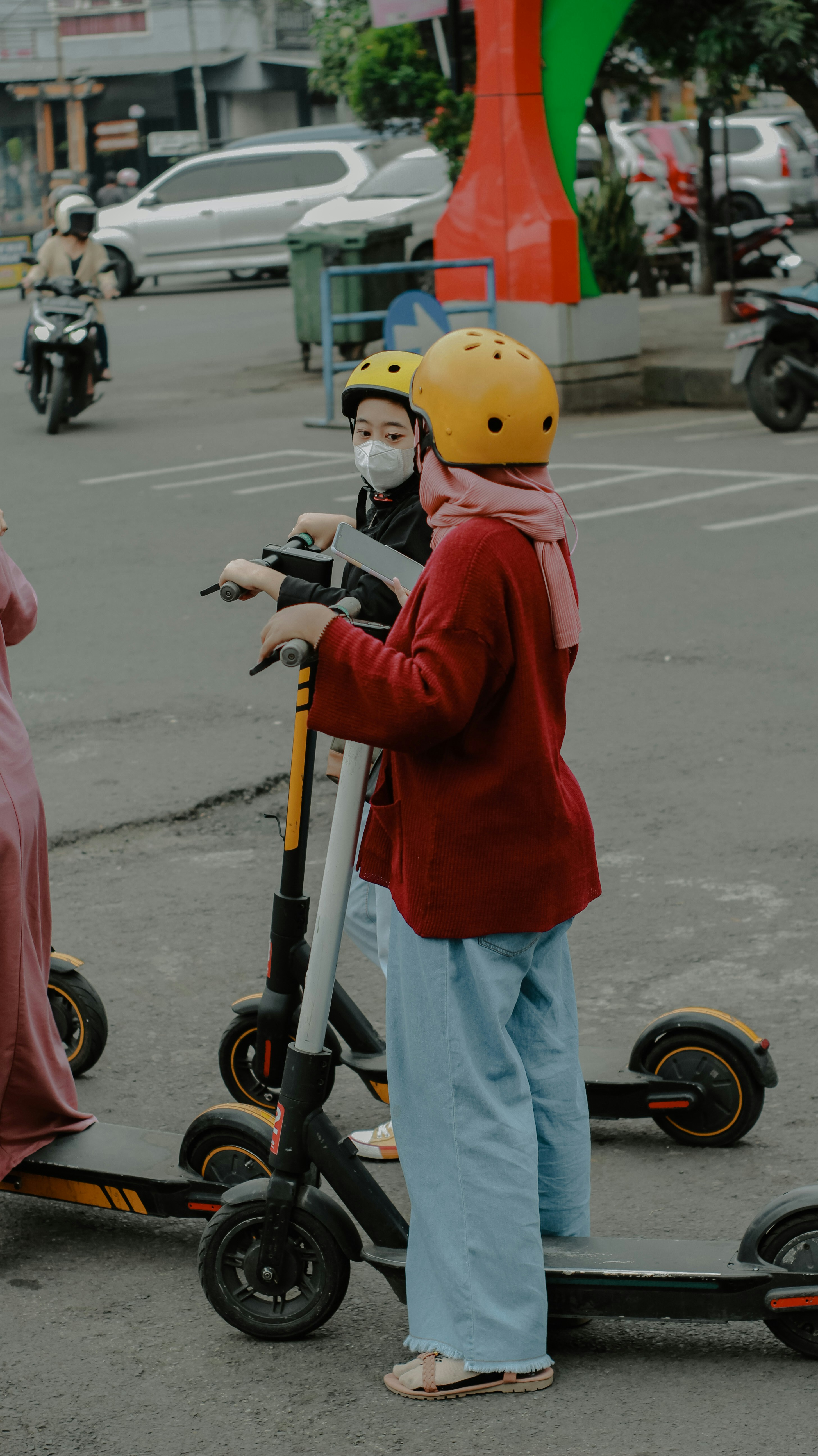 A person riding a scooter with a child on it