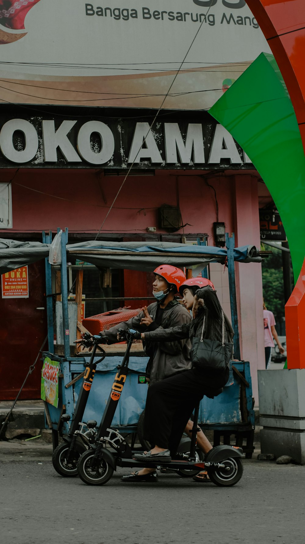 a woman riding a scooter down a street