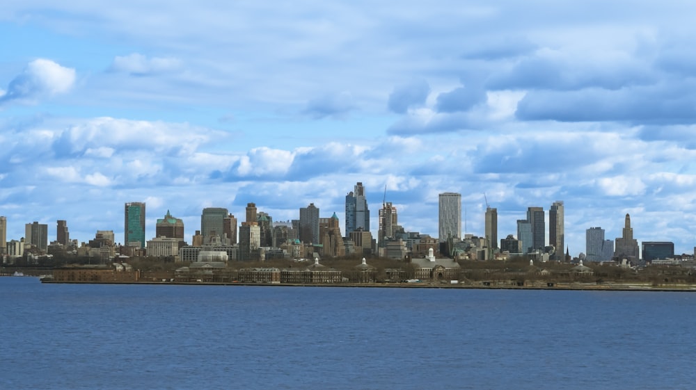 a large body of water with a city in the background