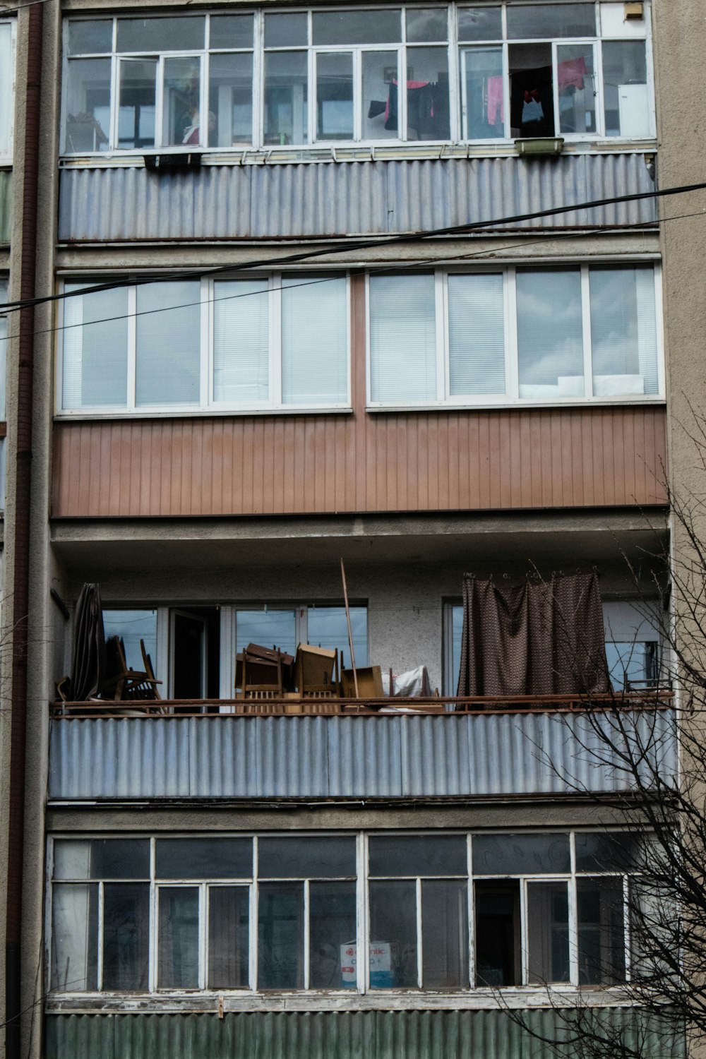 a tall building with lots of windows next to a street