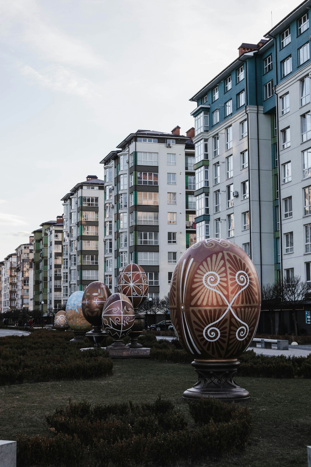 a group of large eggs sitting on top of a lush green field