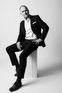 photography poses for men,how to photograph best ager model in studio i; a man in a suit sitting on a stool