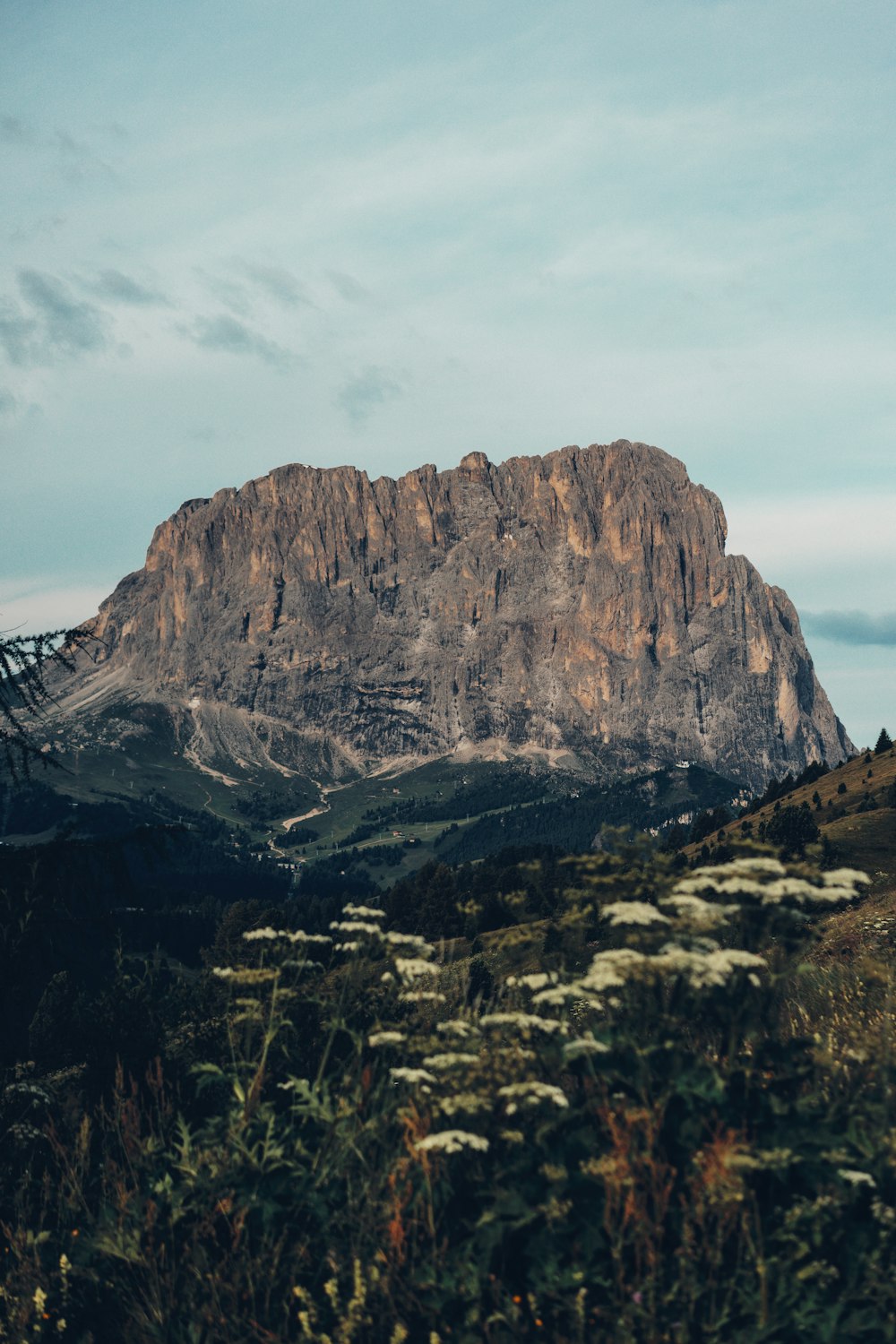 a large mountain with a very tall mountain in the background