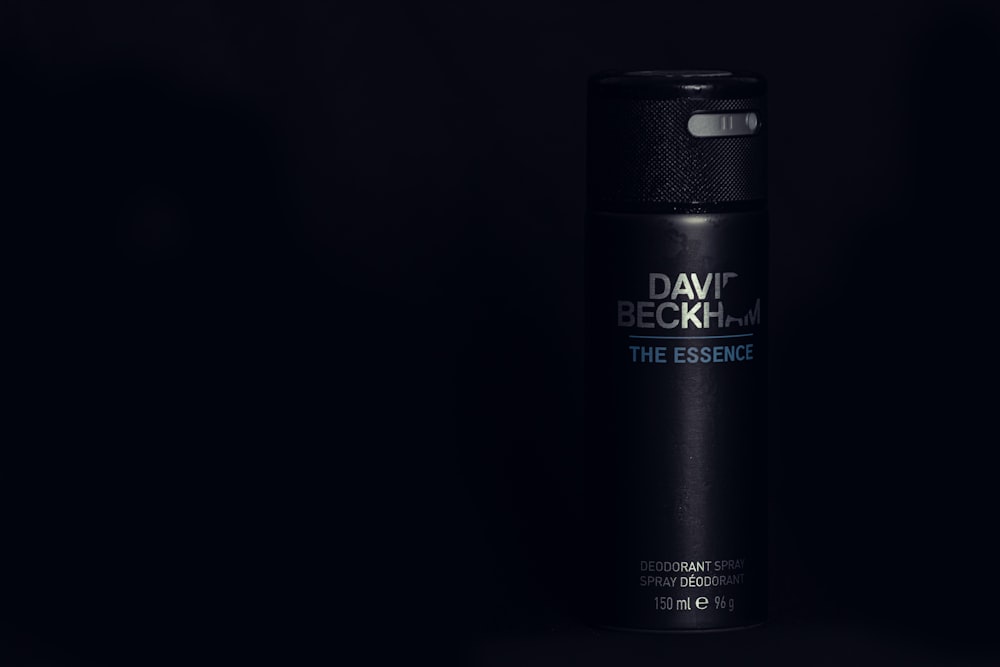 a bottle of deodorant on a black background