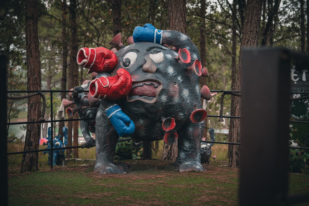 a large statue of a bull with red and blue boxing gloves on it's